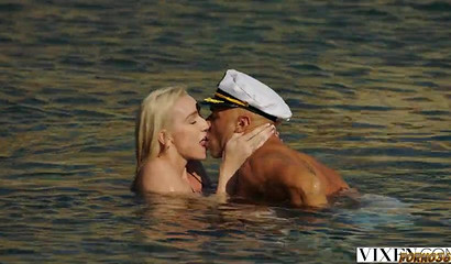 Busty blonde bombshell gets face fucked by captain on the beach