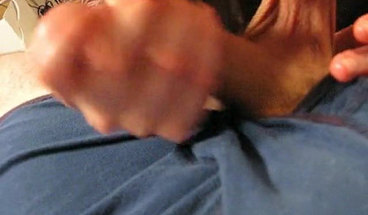 Busty brunette pouring oil on a cock before gagging on it