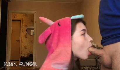 Beautiful girl in an unicorn costume giving sloppy head