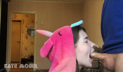Beautiful girl in an unicorn costume giving sloppy head