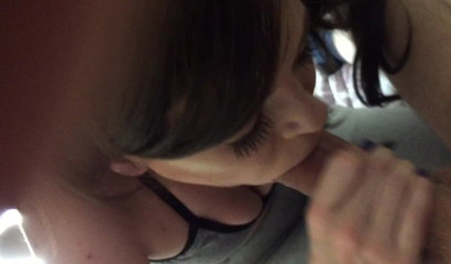 An adorable brunette gives her husband head before swallowing him