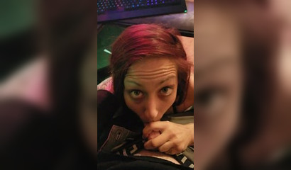 Redhead gamer girl rests her trigger finger by sucking her man's penis