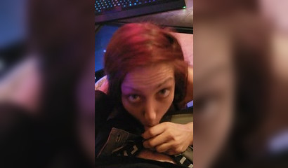 Redhead gamer girl rests her trigger finger by sucking her man's penis