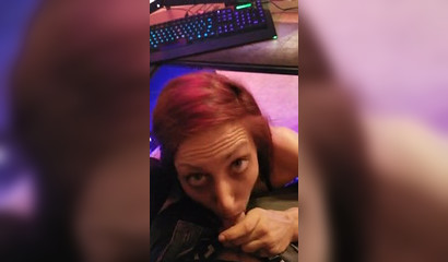 Redhead gamer girl rests her trigger finger by sucking her man's penis