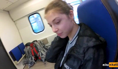 European slut reaches over and performs a public train blowjob