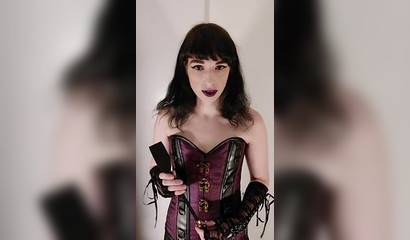 Dark-haired femdom posing in her sexy outfit