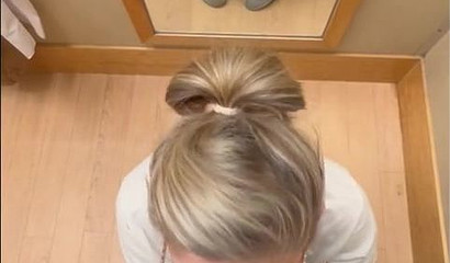 Nerdy tattooed blonde giving a blowjob in the dressing room