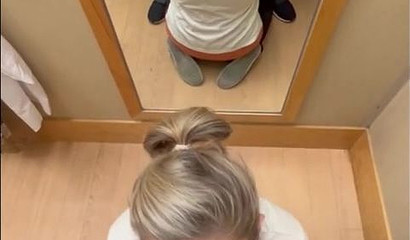 Nerdy tattooed blonde giving a blowjob in the dressing room