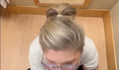 Nerdy tattooed blonde giving a blowjob in the dressing room