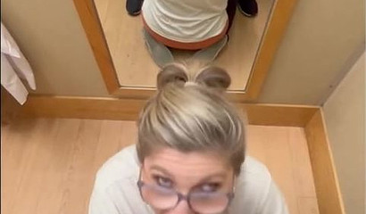 Nerdy tattooed blonde giving a blowjob in the dressing room