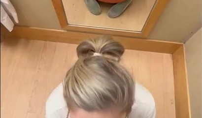 Nerdy tattooed blonde giving a blowjob in the dressing room