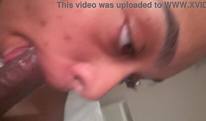 Ebony cutie gazes up during a BBC blowjob