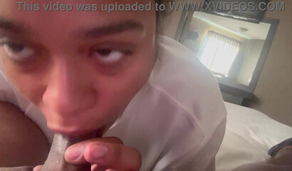 Ebony cutie gazes up during a BBC blowjob