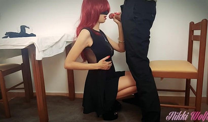 Redhead slut with mask kneels under table and sucks fat cock dry