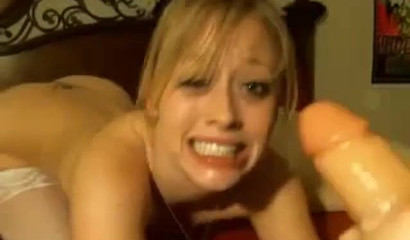 Little vixen in white stockings throating a dildo