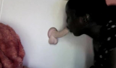 Black beauty blowing a white toy attached to the wall