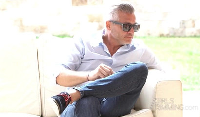 Afrodite and Vicky Love performing a rimjob in an outdoor threesome