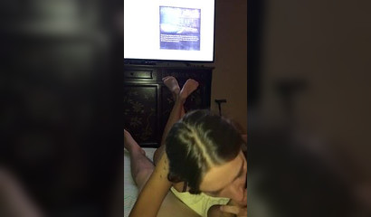 Watching TV while getting a blowjob