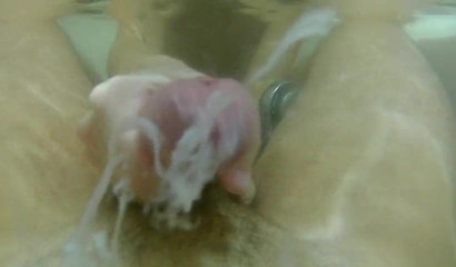 Skilled hottie jerking off a big cock in the bathtub