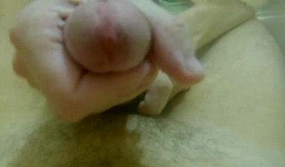 Skilled hottie jerking off a big cock in the bathtub