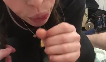 Brunette makes an eye contact while sucking a dick and balls