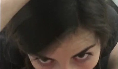 Brunette makes an eye contact while sucking a dick and balls