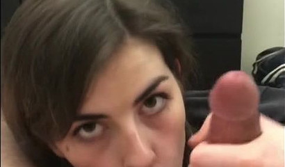 Brunette makes an eye contact while sucking a dick and balls